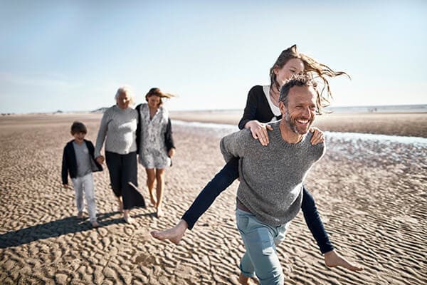 family walking on the beach